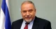 Avigdor Lieberman speaking in front of an Israeli flag