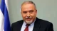 Avigdor Lieberman speaking in front of an Israeli flag