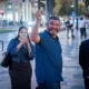 Ofer Winter smiling and waving on a city street
