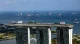 Aerial view of Marina Bay Sands with cargo ships anchored in the strait behind it