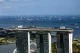 Aerial view of Marina Bay Sands with cargo ships anchored in the strait behind it